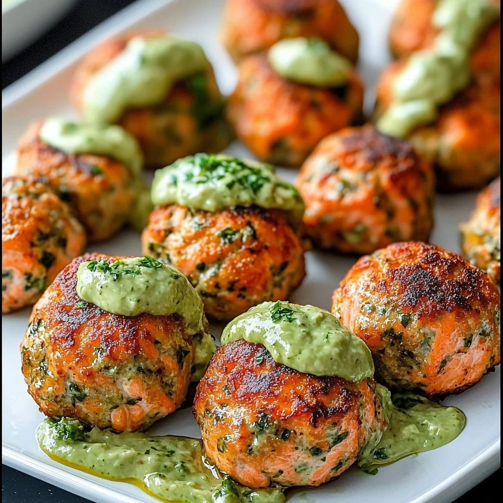 Baked salmon meatballs served with avocado sauce on a plate
