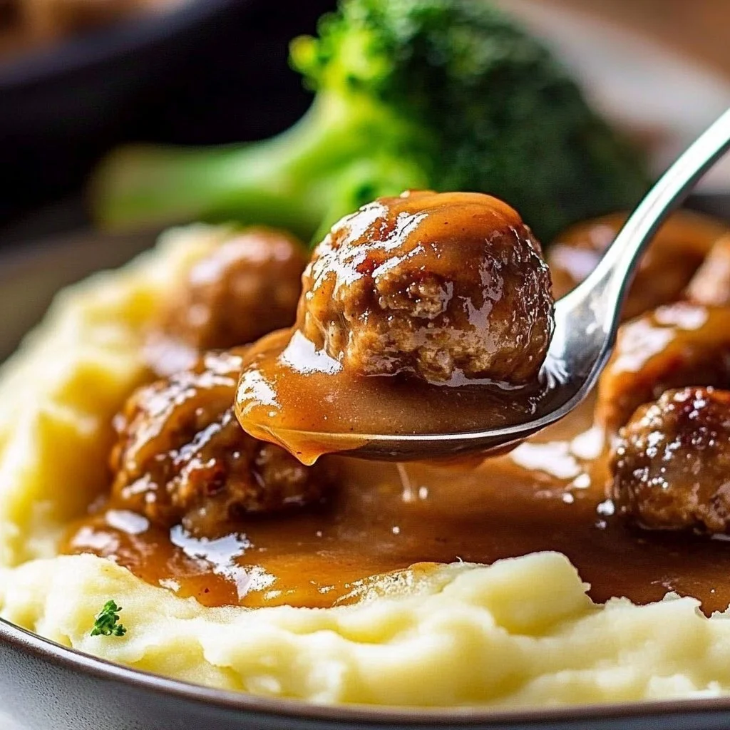 Salisbury meatballs served with fluffy mashed potatoes on a plate