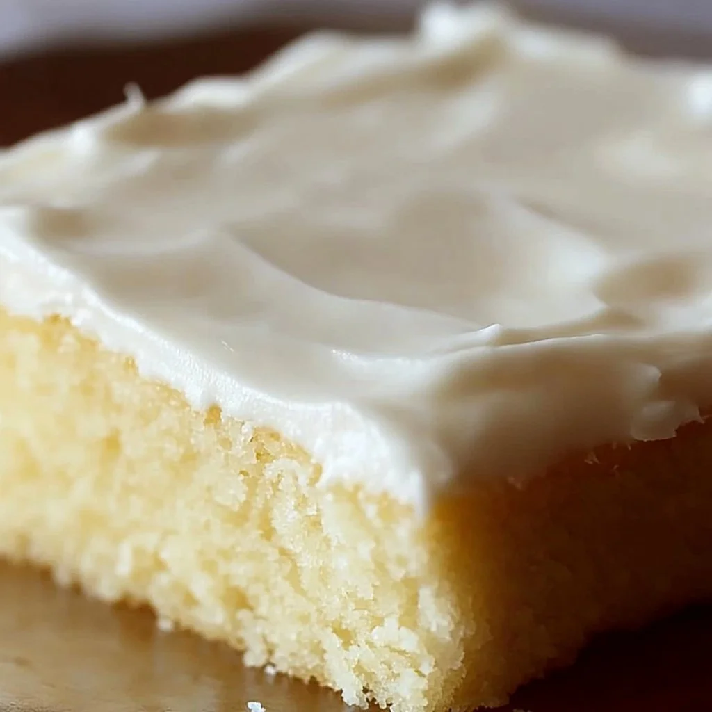 Delicious White Texas Sheet Cake served on a rustic wooden table